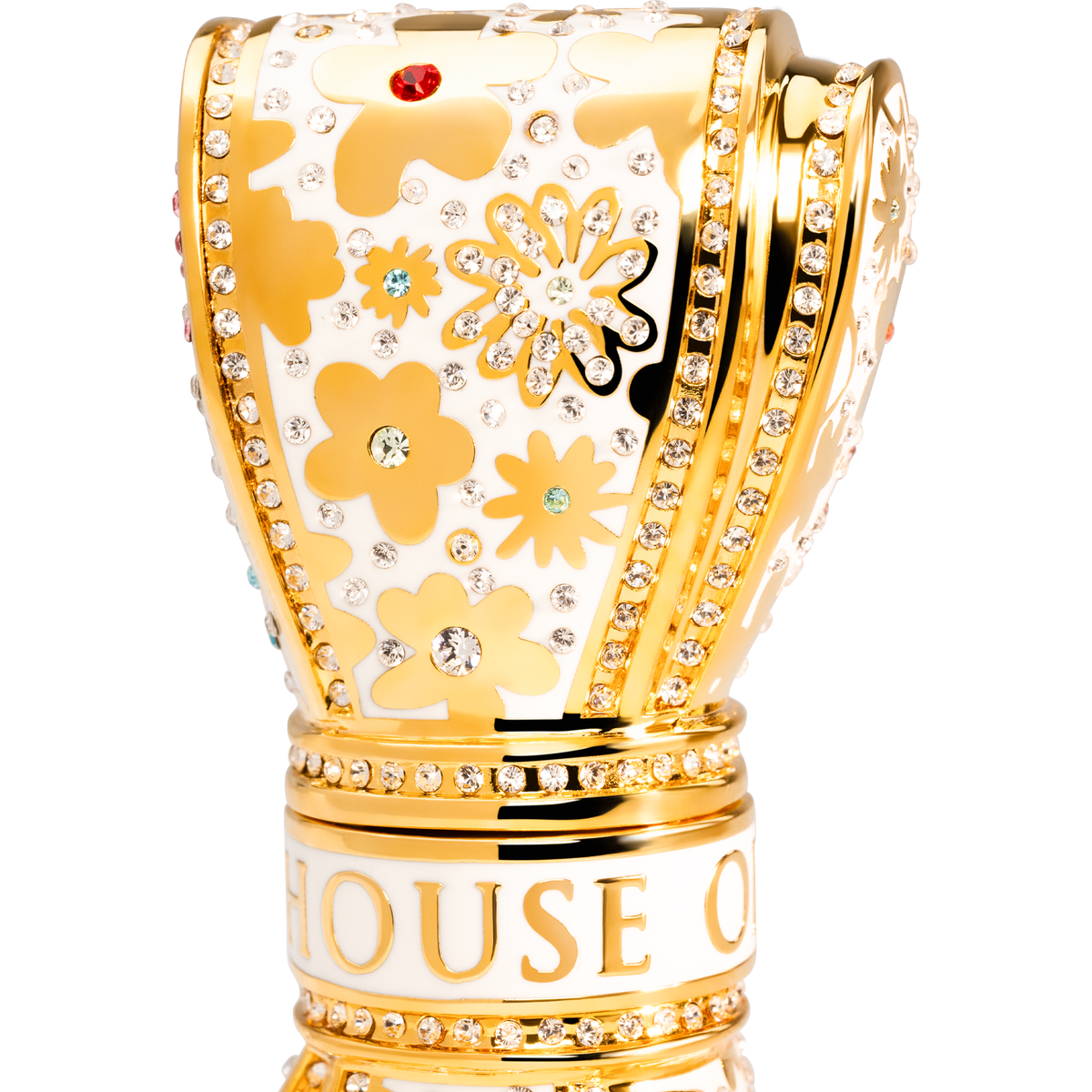 Gold and white decorative  luxury lipstick with floral patterns and 'House of' branding on a white background