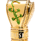 Gold perfume bottle with green gemstone design gecko. 