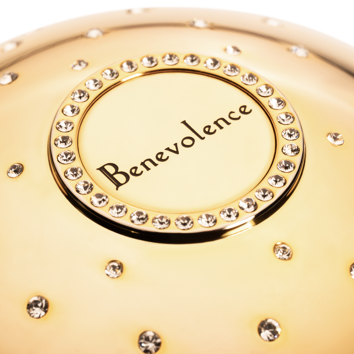 Gold cup of luxury fragrance  with 'Benevolence' branding and crystal embellishments