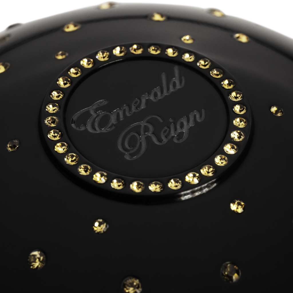 Black luxury fragrance cup with gold crystals  and 'Emerald Reign' branding 
