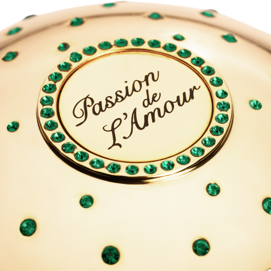 Gold niche fragrance cup  with 'Passion de L'Amour' text and green gemstones