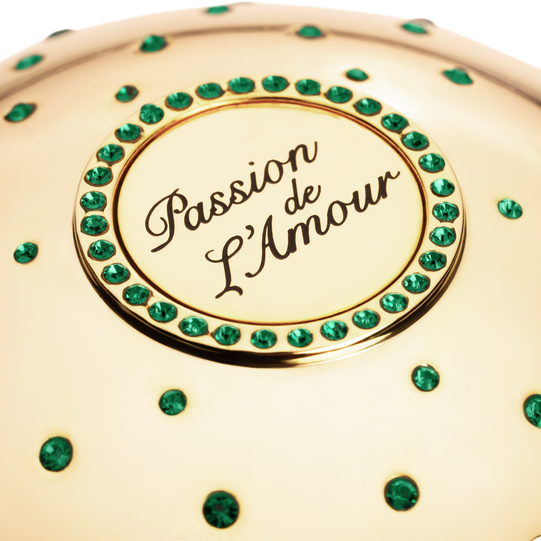 Gold niche fragrance cup  with 'Passion de L'Amour' text and green gemstones