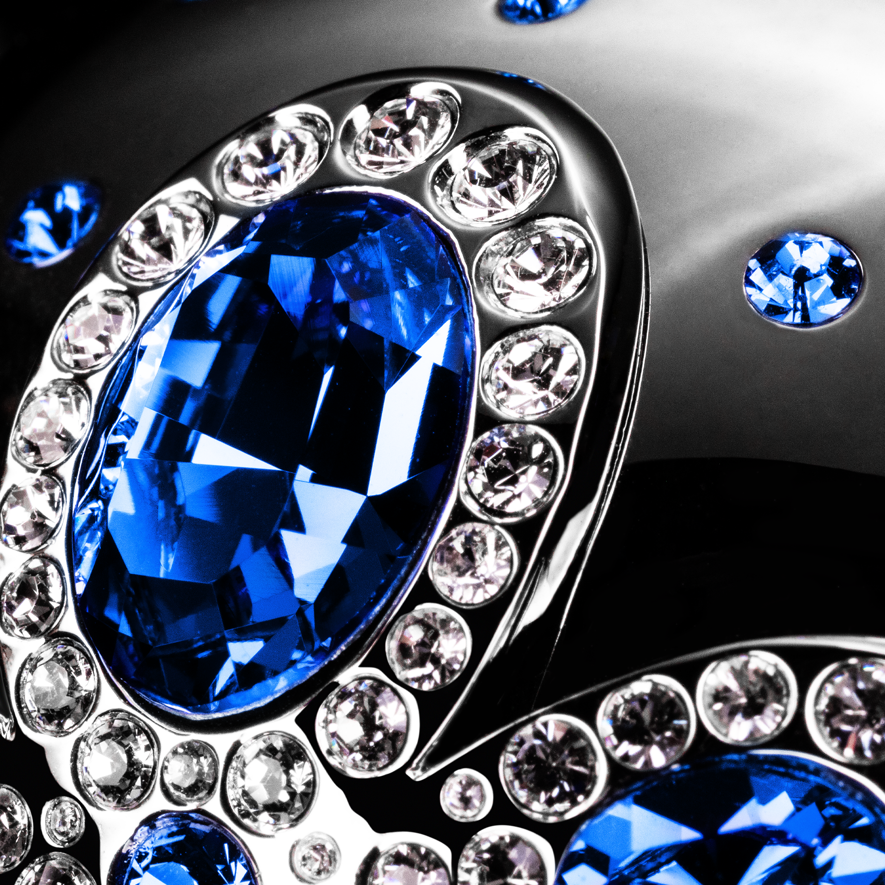 Close-up of a decorative element with blue gemstones and clear crystals.
