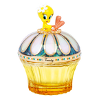 Tweety sitting on luxury fragrance bottle